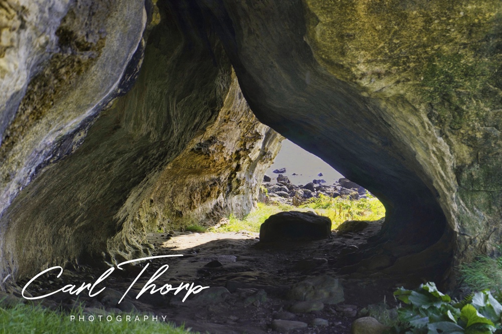 Looking through a natural rock arch to the sea on the Isle of Arran